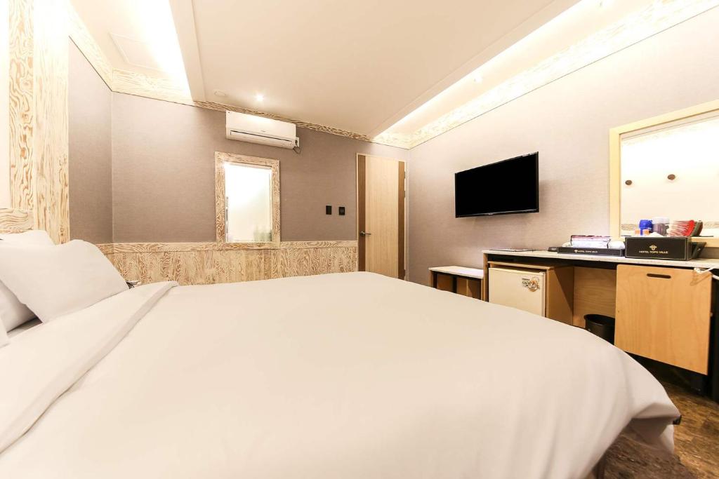 Postel nebo postele na pokoji v ubytování Hotel TopsVille