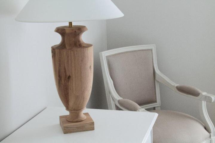 a lamp sitting on a table next to a chair at B&B Le Biciclette in San Vito lo Capo