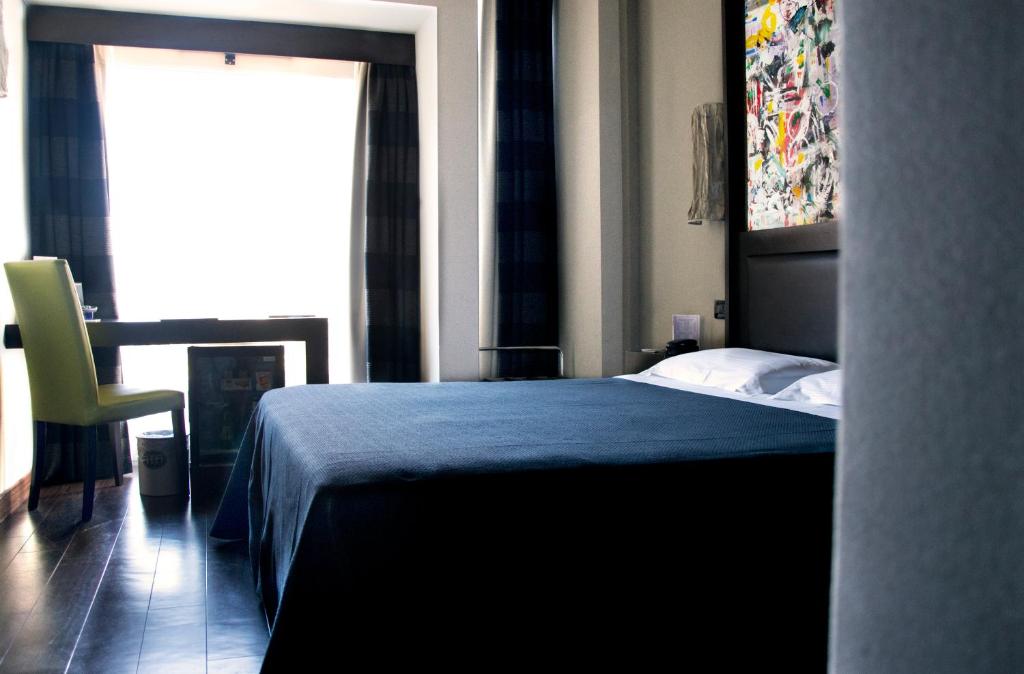 Postel nebo postele na pokoji v ubytování Twentyone Hotel