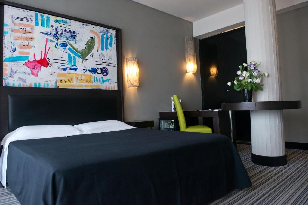 Postel nebo postele na pokoji v ubytování Twentyone Hotel