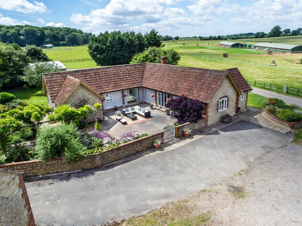 an aerial view of a house with a patio at The Farm House Nables Farm in Chippenham