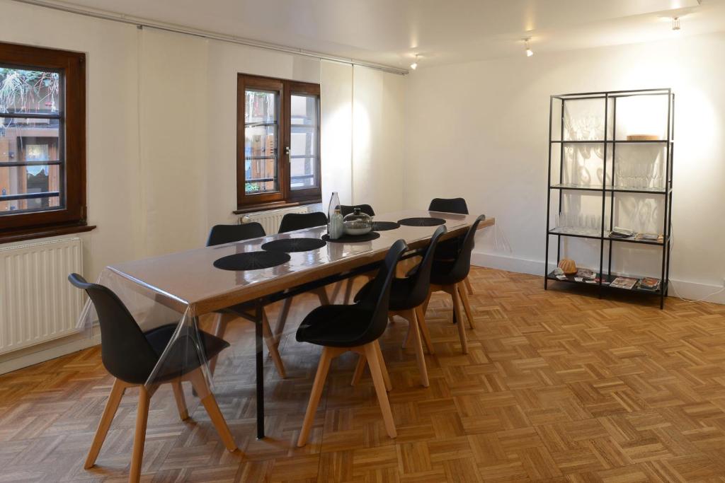 a room with a long table and chairs at KAYSERSBERG city center - House &quot;AUX 7 FORGERONS&quot; - in Kaysersberg