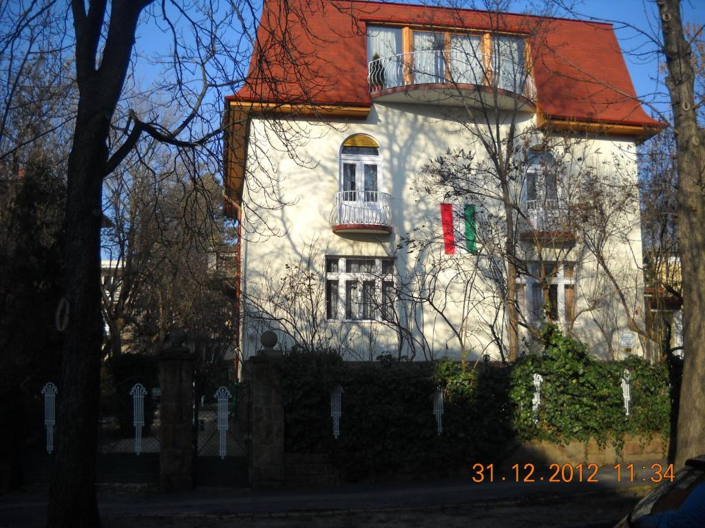 a white building with a red roof at Villa Julia in Budapest