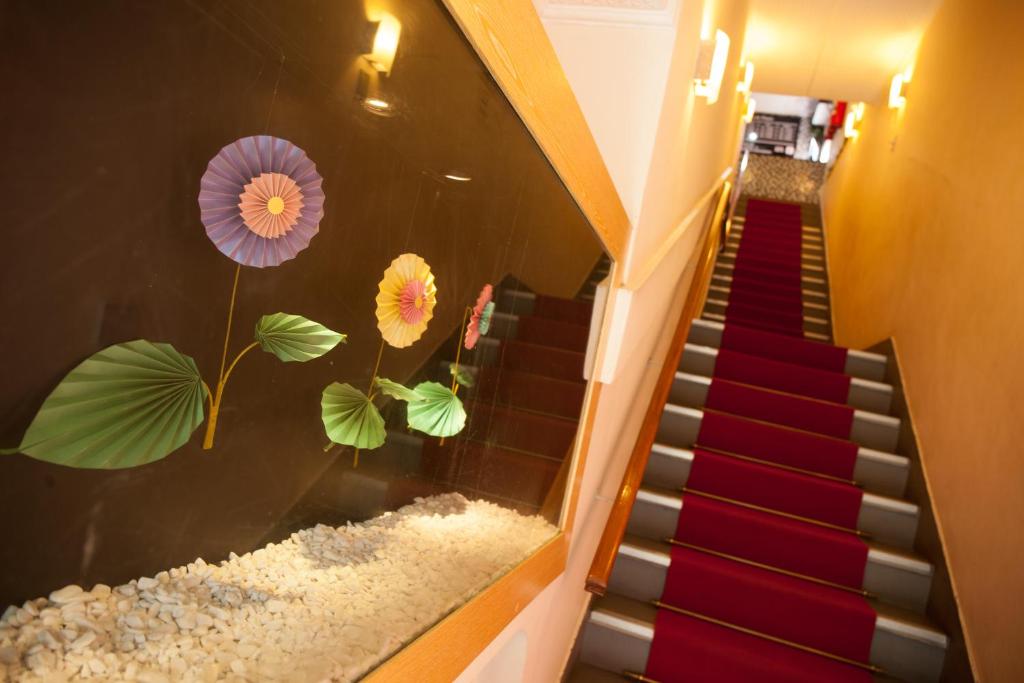 a staircase with a mural of flowers on the wall at Hotel Jardim América ( Adults only) in Sao Paulo
