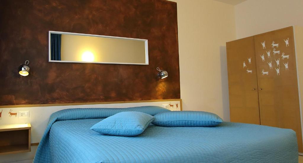Postel nebo postele na pokoji v ubytování Hotel Giardino