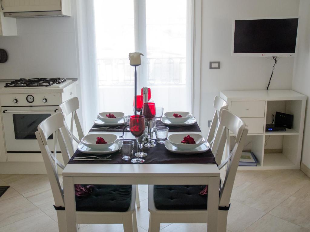 mesa de comedor con sillas y mesa con copas de vino en Cheap & Chic Thermae&Relax, en Abano Terme