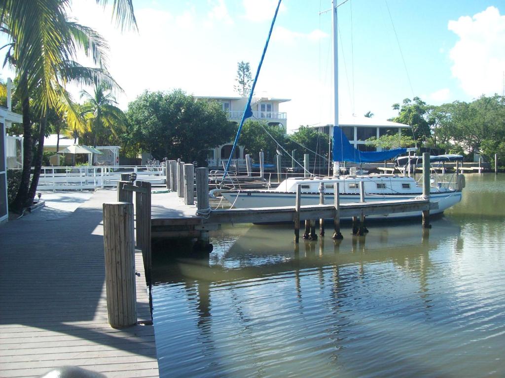 a boat docked at a dock in the water at Kingsail Resort in Marathon