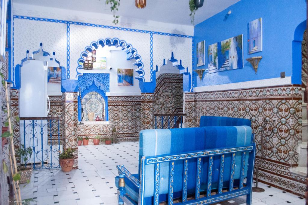 a blue and white room with blue chairs in it at Hotel Abi khancha in Chefchaouen