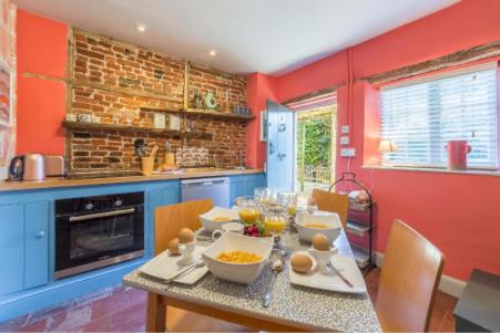 a kitchen with a table with bowls of food on it at No33 THORNHAM BOUTIQUE COTTAGE 3 in Thornham