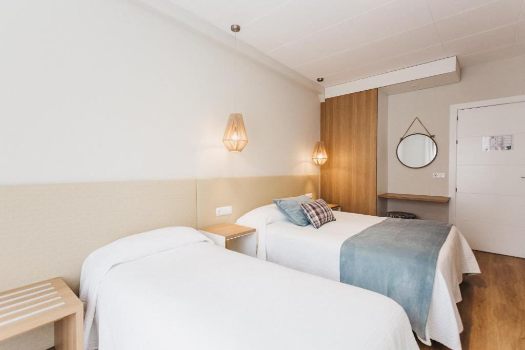 Postel nebo postele na pokoji v ubytování Hotel Catalunya Ribes de Freser