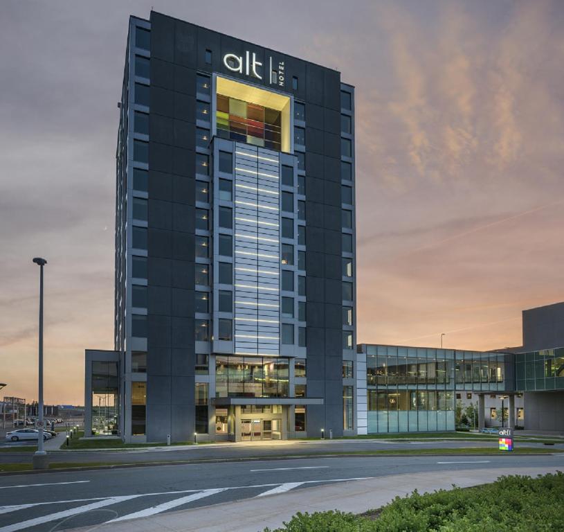a rendering of the office building at dusk at Alt Hotel Halifax Airport in Enfield