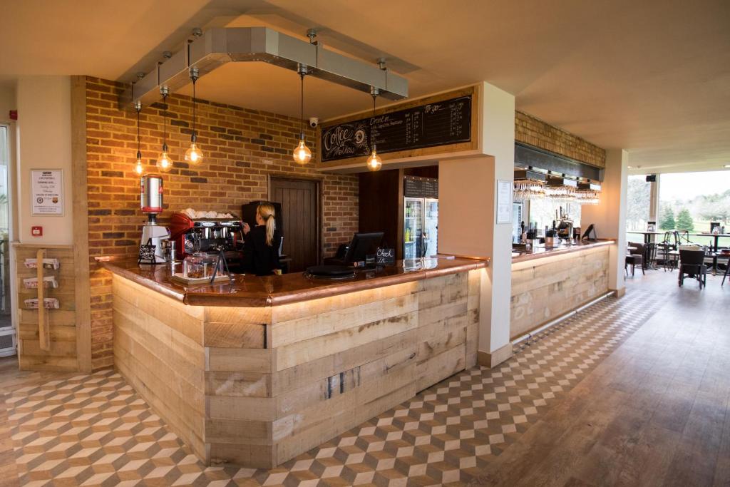 a bar in a restaurant with a brick wall at The View in Welwyn Garden City