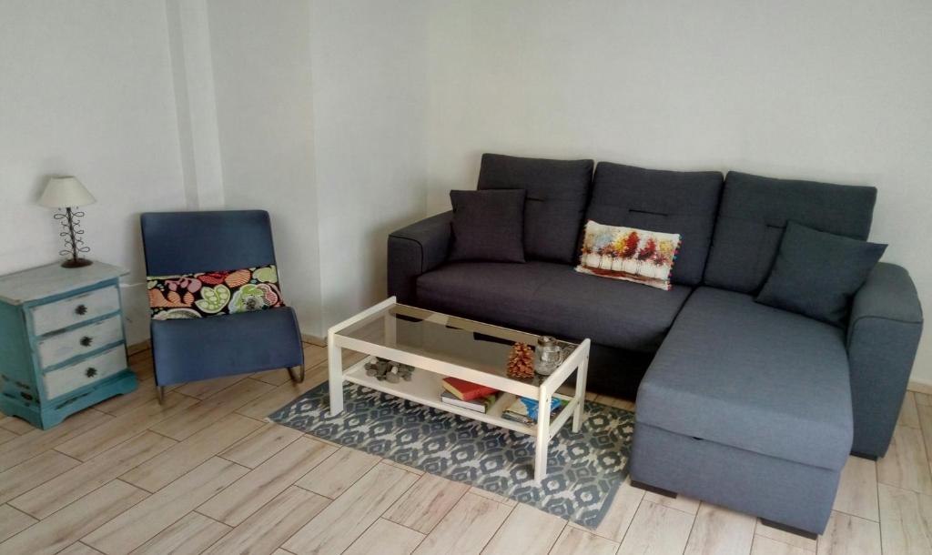 a living room with a couch and a chair at Apartments Tazacorte Beach 2-3 floor in Tazacorte