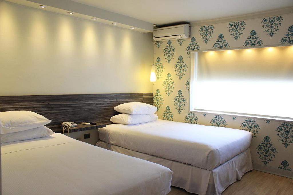 Una cama o camas en una habitación de Hotel Las Terrazas Business