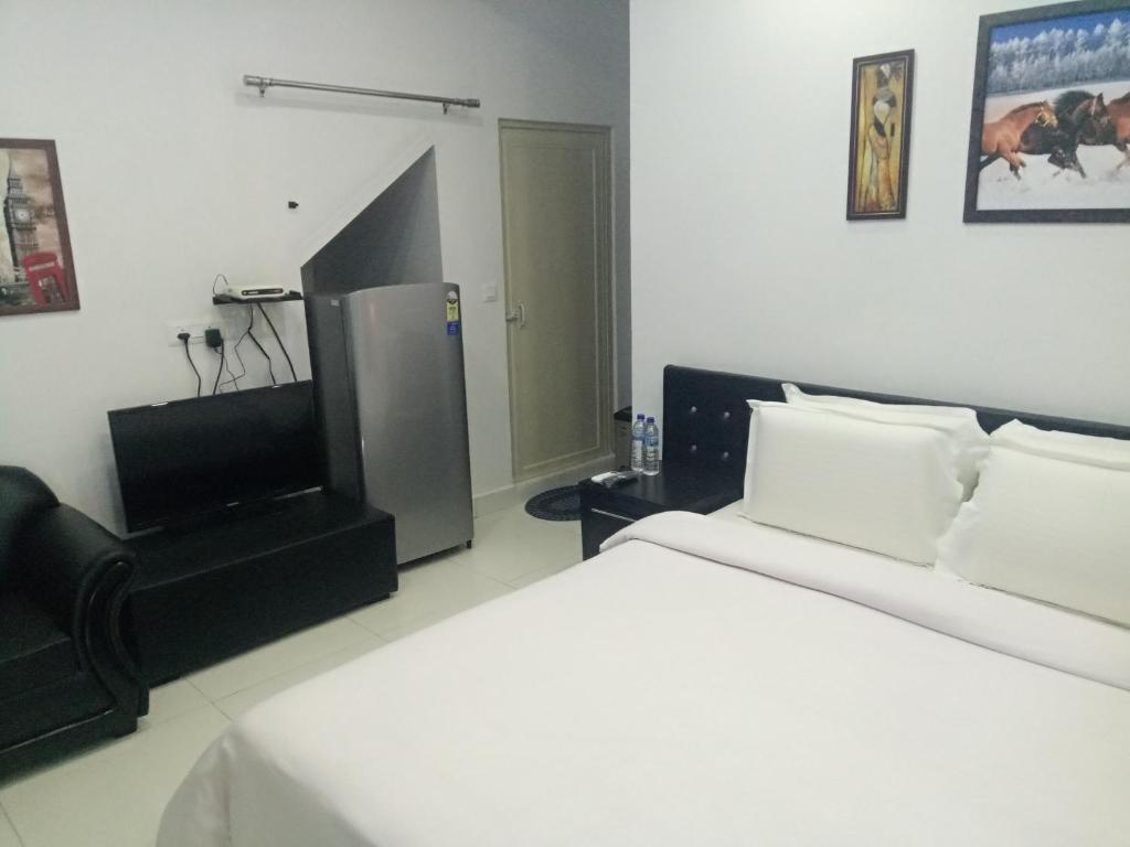 Postel nebo postele na pokoji v ubytování J. I. T HOTEL