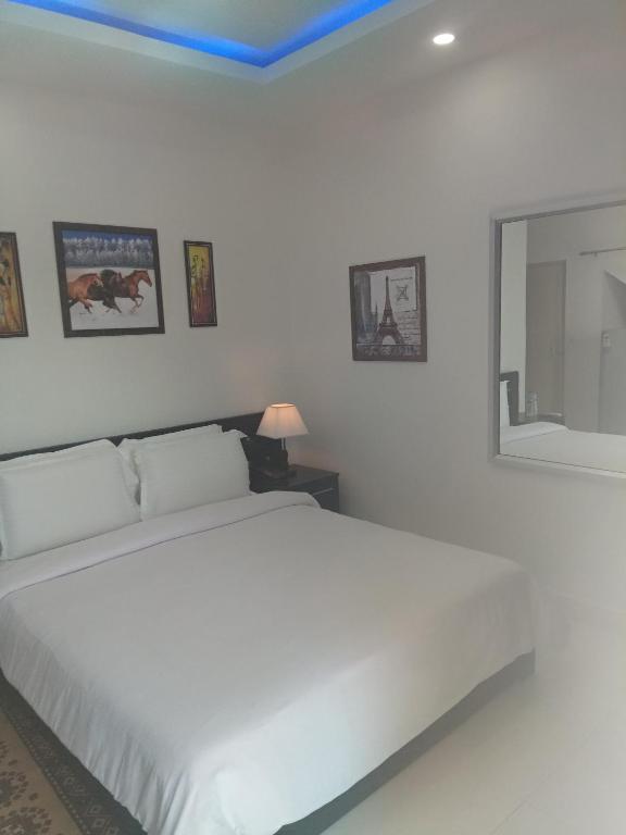 Postel nebo postele na pokoji v ubytování J. I. T HOTEL