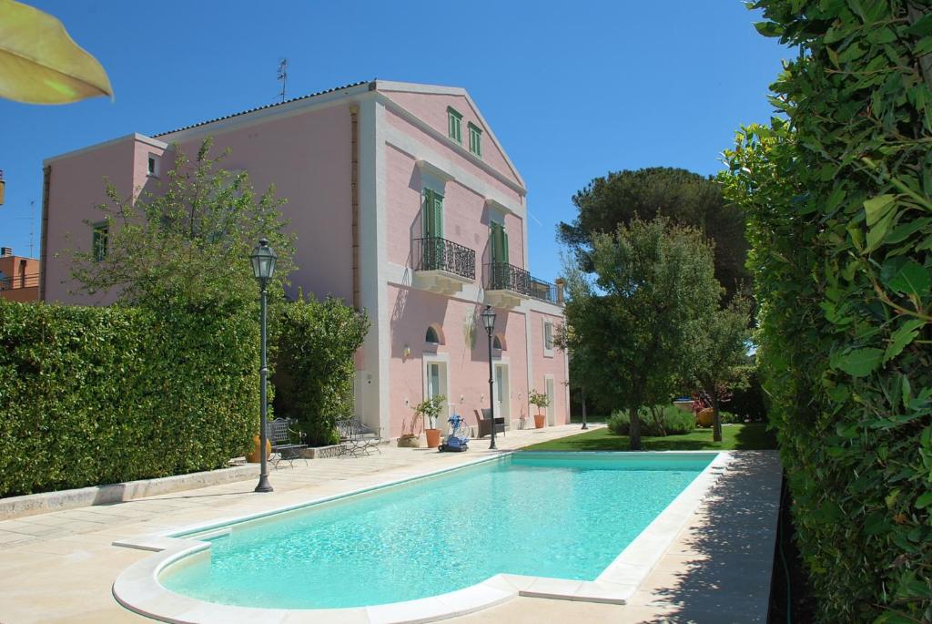 a swimming pool in front of a building at Hotel Casino Ridola in Matera