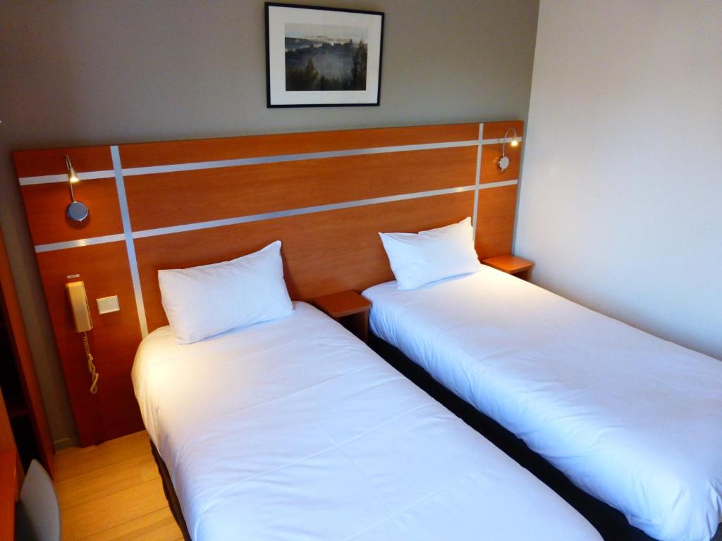 Postel nebo postele na pokoji v ubytování Hotel & Restaurant Heliotel