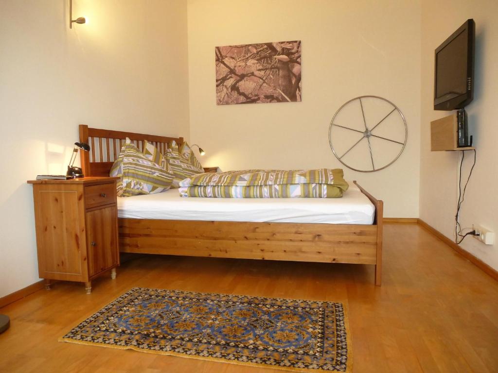 a bedroom with a bed and a television and a rug at Charming, central, spacious apartment in Innsbruck