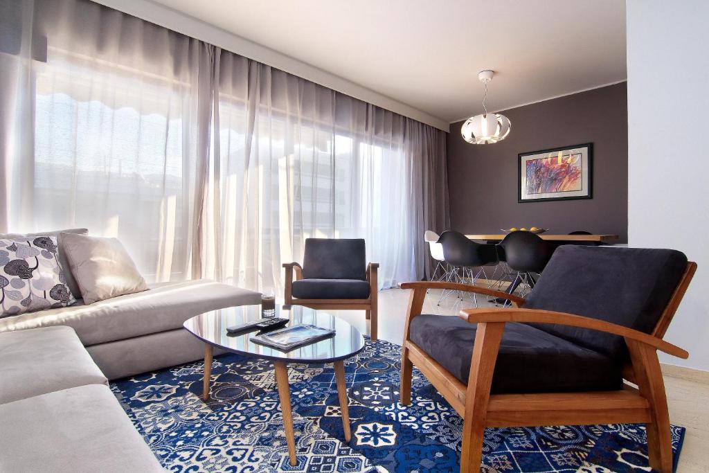 a living room with a couch and a table at Central Apartment in Athens