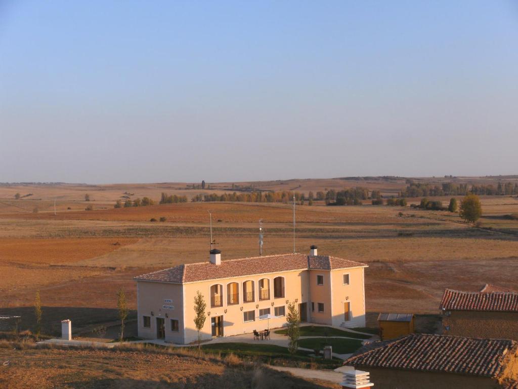 a building in the middle of a field at Hostal Moratinos in Moratinos