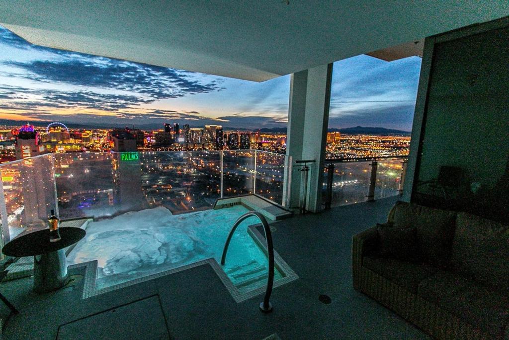 a room with a view of a city at night at Dream Penthouse at Palms Place in Las Vegas