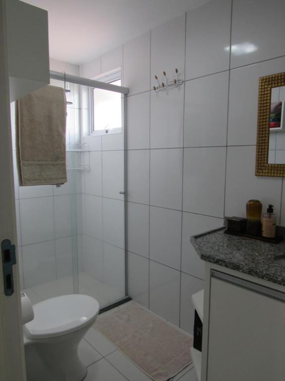 a white bathroom with a toilet and a shower at Smart Residence Flat - FLAT 1009 in Teresina