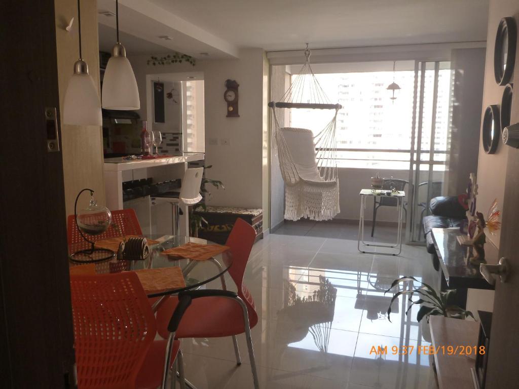 a kitchen and dining room with a table and chairs at Apartamento en colores y o cabaña hermosa in Medellín