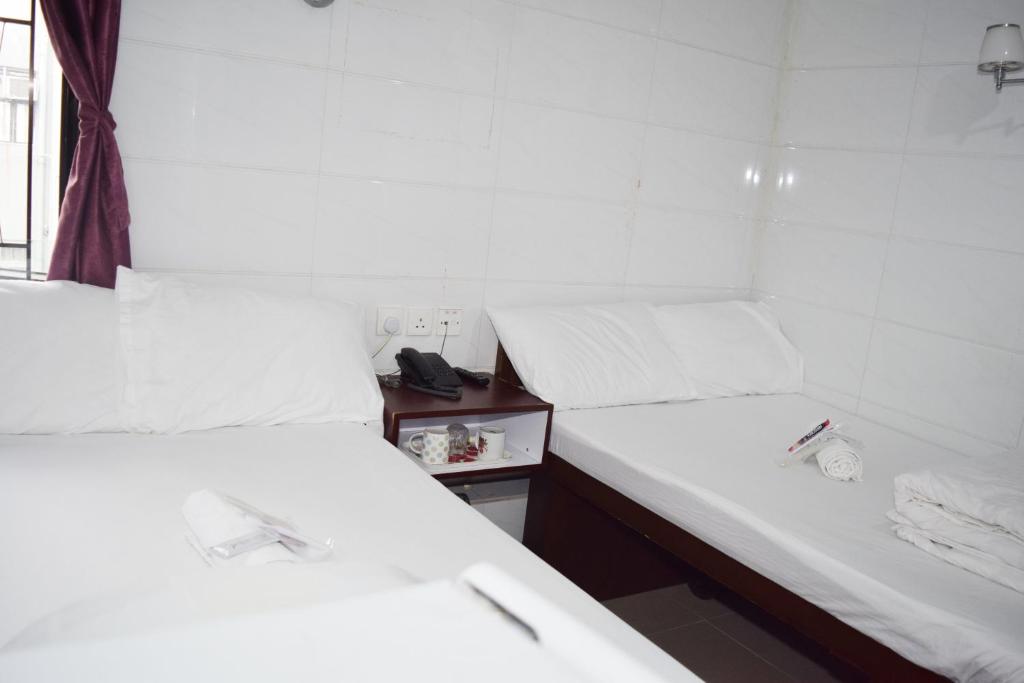 Postel nebo postele na pokoji v ubytování Pay-Less Guesthouse (7/F A9)
