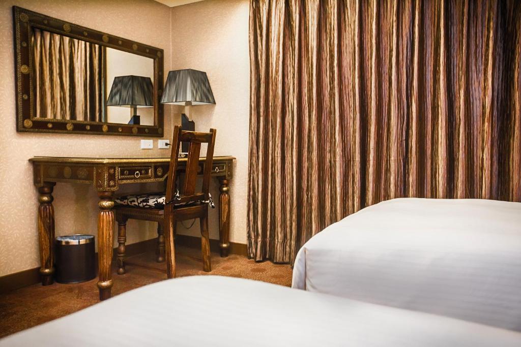 Postel nebo postele na pokoji v ubytování Cai She Hotel