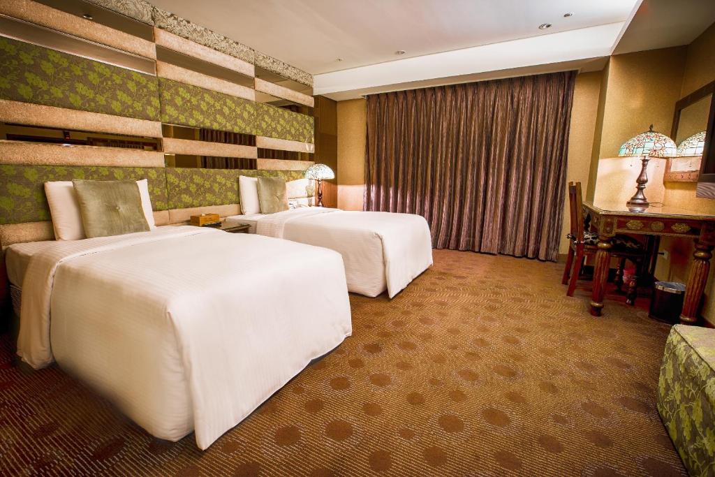 Postel nebo postele na pokoji v ubytování Cai She Hotel