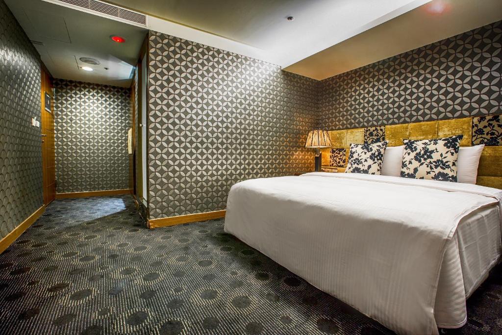 Postel nebo postele na pokoji v ubytování Cai She Hotel