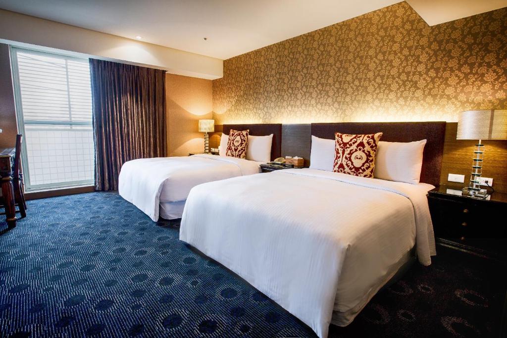 Postel nebo postele na pokoji v ubytování Cai She Hotel