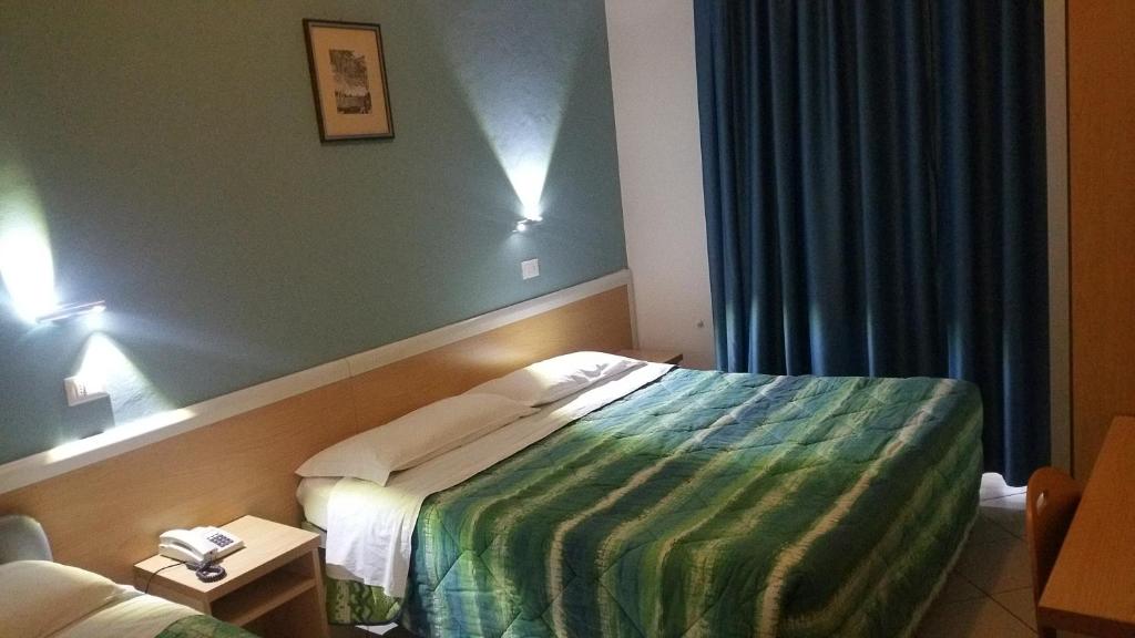 Postel nebo postele na pokoji v ubytování Hotel Savina