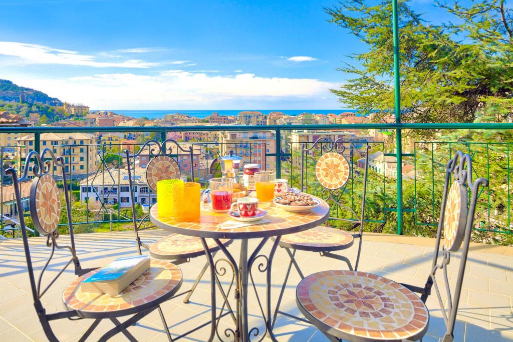 a table and chairs on a balcony with a view at Villa HELVEZIA in Levanto