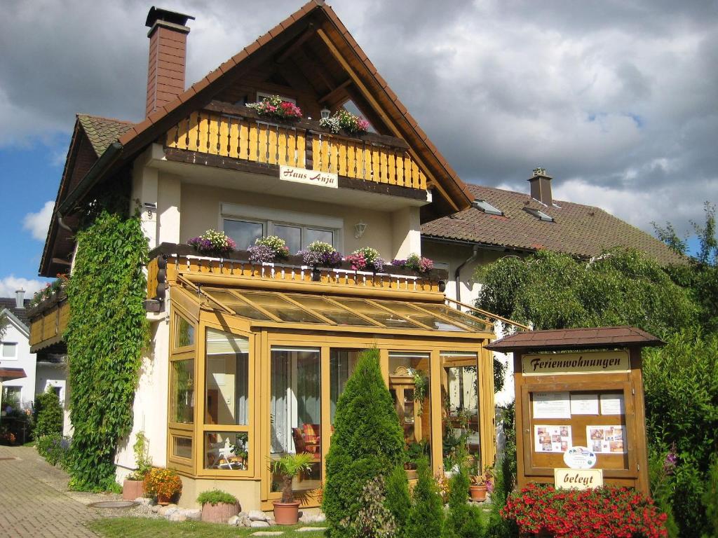 una casa con muchas ventanas y flores en Haus Anja, en Titisee-Neustadt