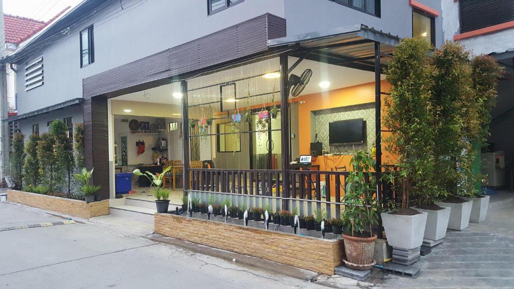 a store front with potted plants in front of it at WJ Residence at Suvarnaphumi in Lat Krabang