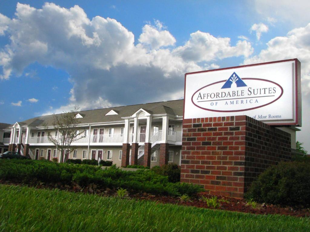 a sign in front of a large building at Affordable Suites Conover / Hickory in Conover