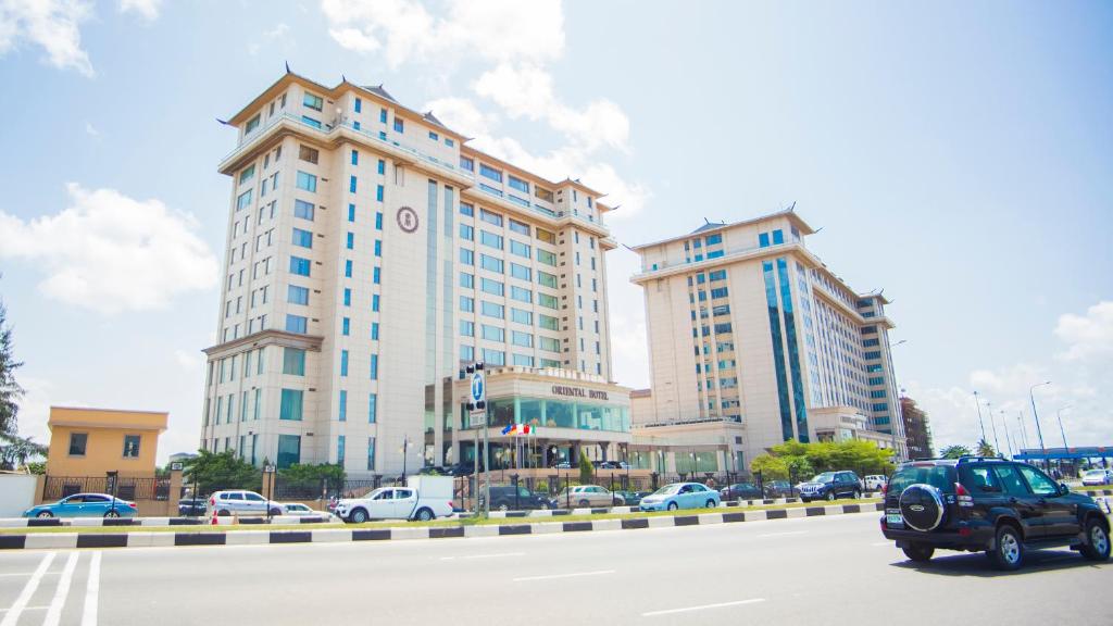 two tall buildings on a city street with cars at Lagos Oriental Hotel in Lagos