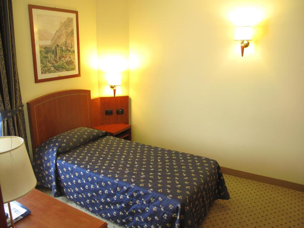 Postel nebo postele na pokoji v ubytování Hotel Olivo