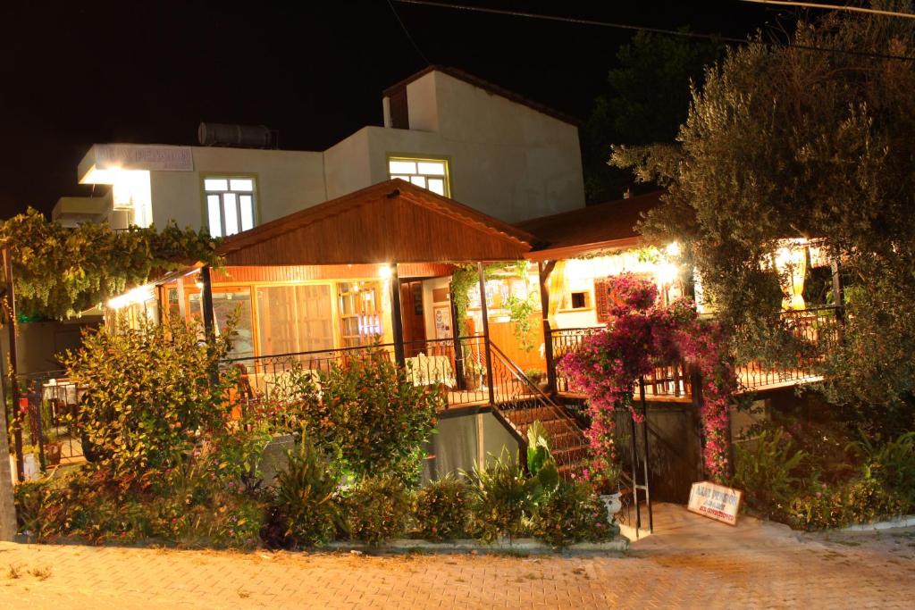a house with lights on it at night at Akay Hotel in Patara