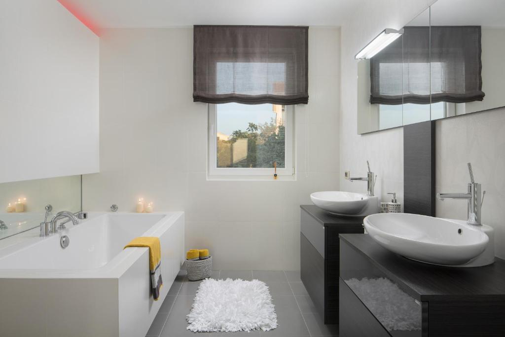 biała łazienka z 2 umywalkami i wanną w obiekcie Villa L - Villa with 2 separate units w mieście Labin