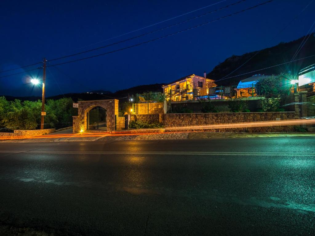 an empty street at night with a building at Palataki in Kardamyli