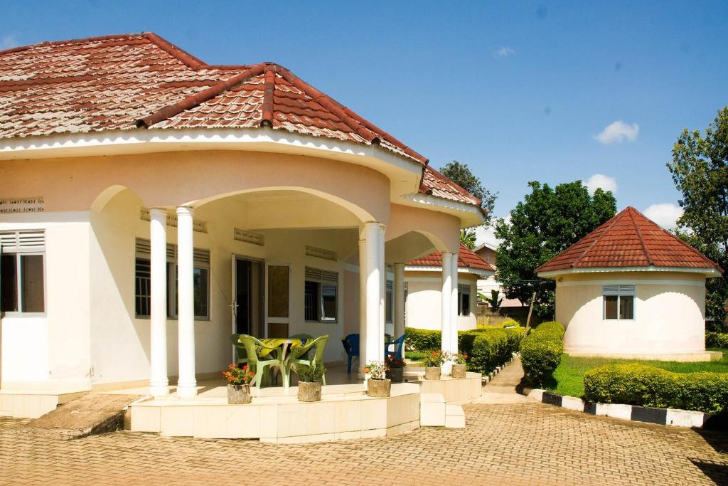 uma casa branca com um telhado vermelho em Marphie Hotel Rukungiri em Rukungiri