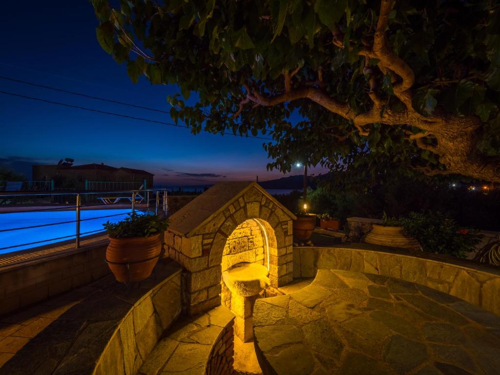 a stone archway in a stone wall at night at Palataki in Kardamyli