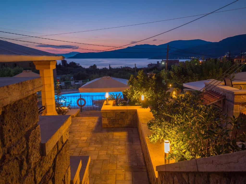 a patio with a view of the ocean at night at Palataki in Kardamyli