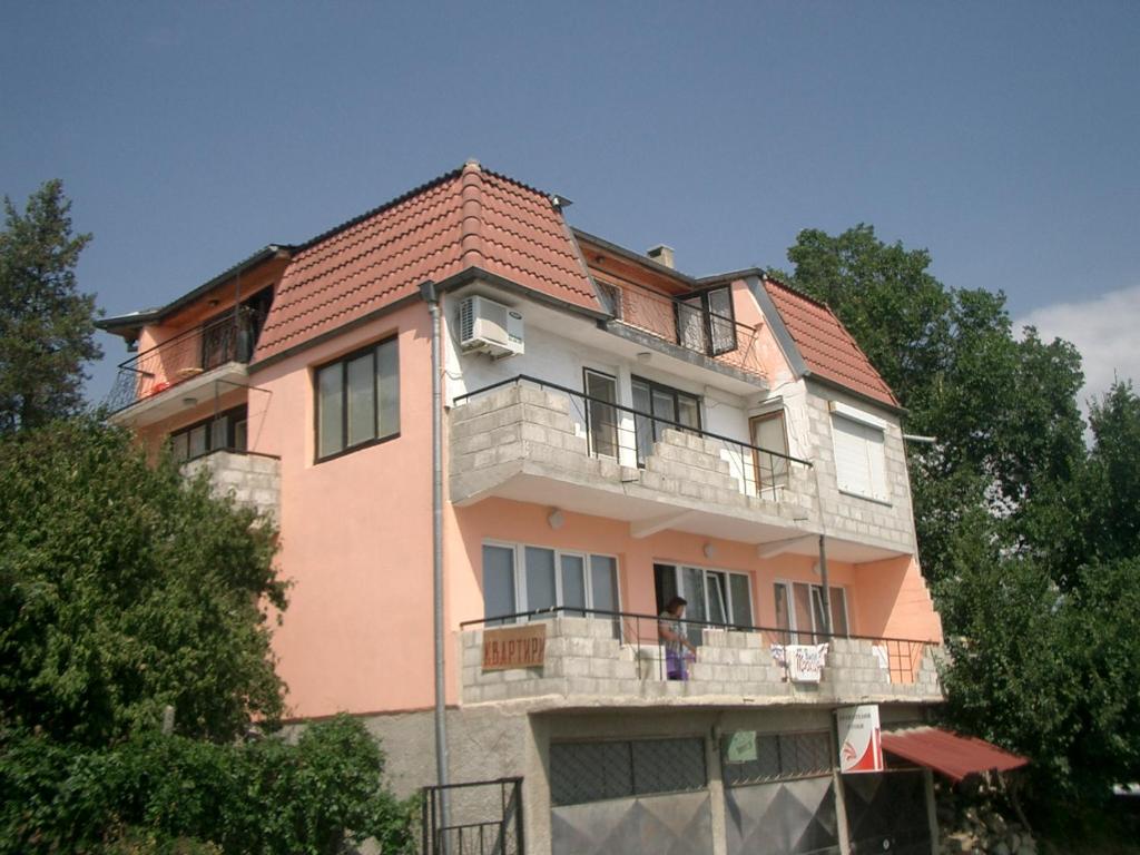 a large pink building with a balcony at Villa Trakia in Golden Sands