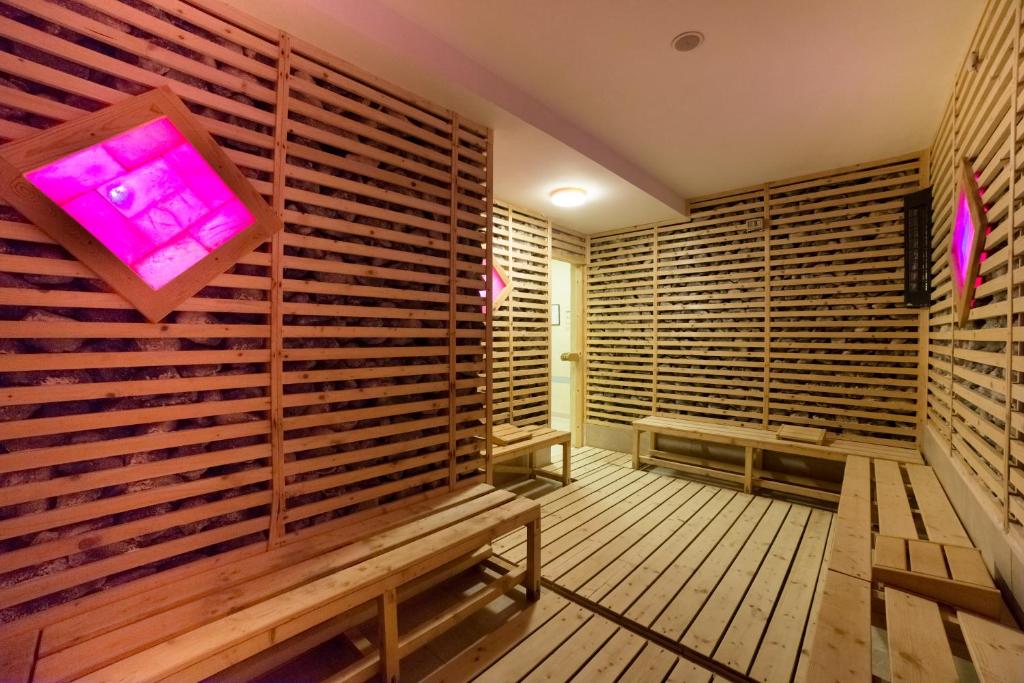 a sauna with a purple light on the wall at Unirea Hotel & Spa in Iaşi