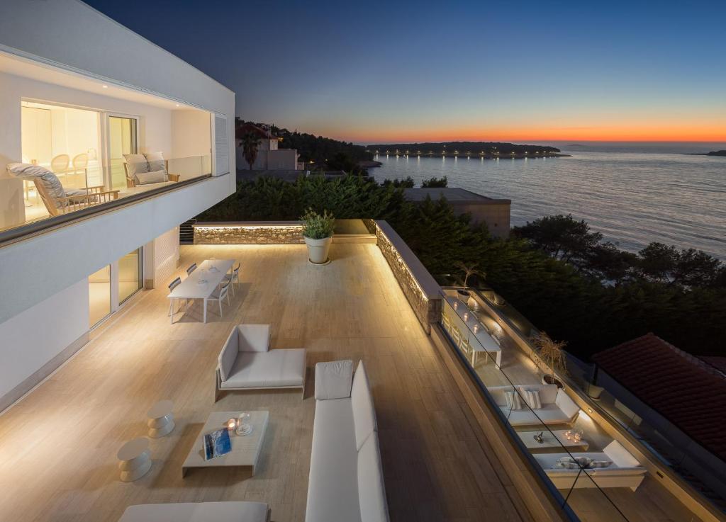 a balcony of a building with a view of the ocean at Apartments Coral in Primošten