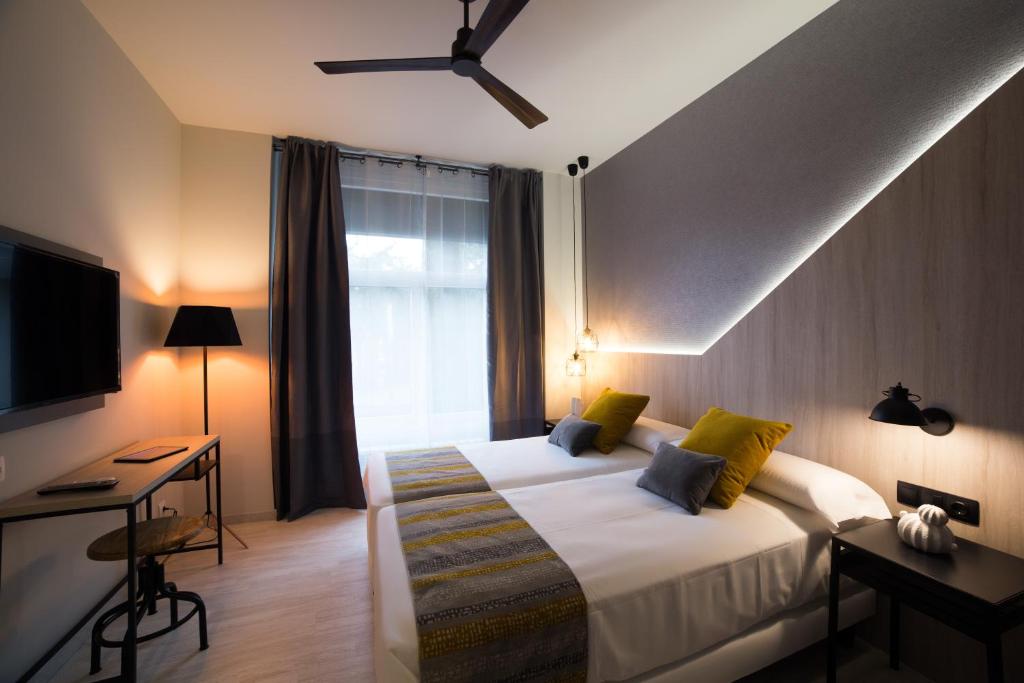 Postel nebo postele na pokoji v ubytování Hotel Onyarbi